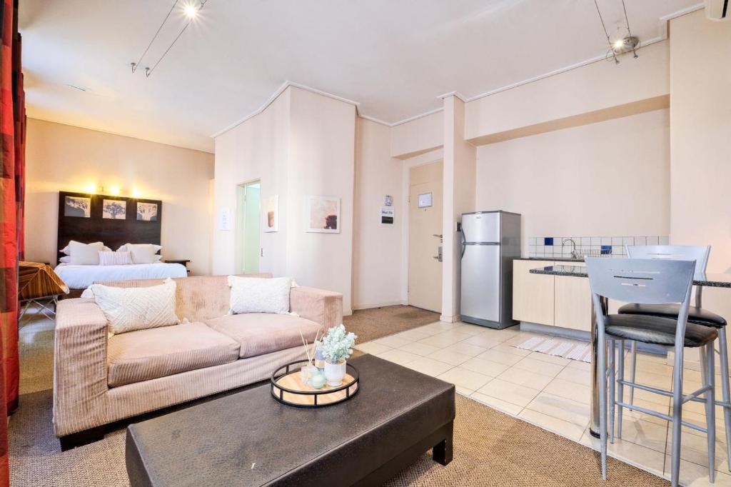 a living room with a couch and a table at Isiphephelo Property in Johannesburg
