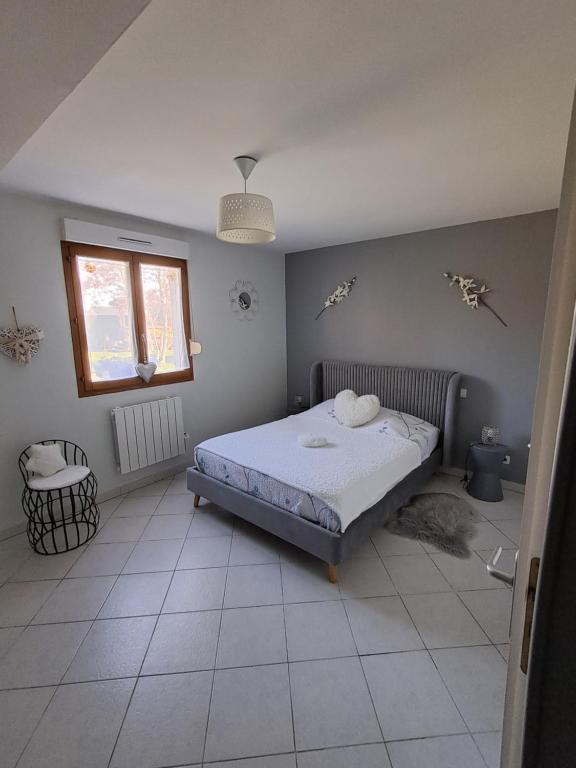 a bedroom with a bed in the corner of a room at La salicorne in Pendé