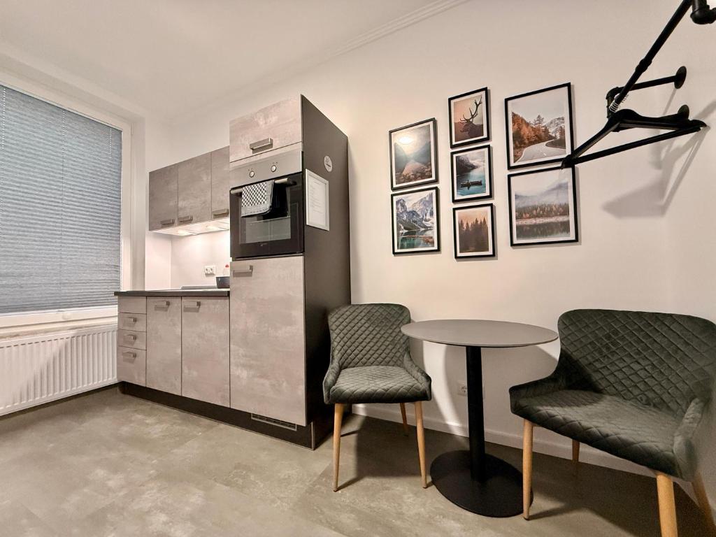a kitchen with a table and two chairs at Smart Business Studio in Itzehoe