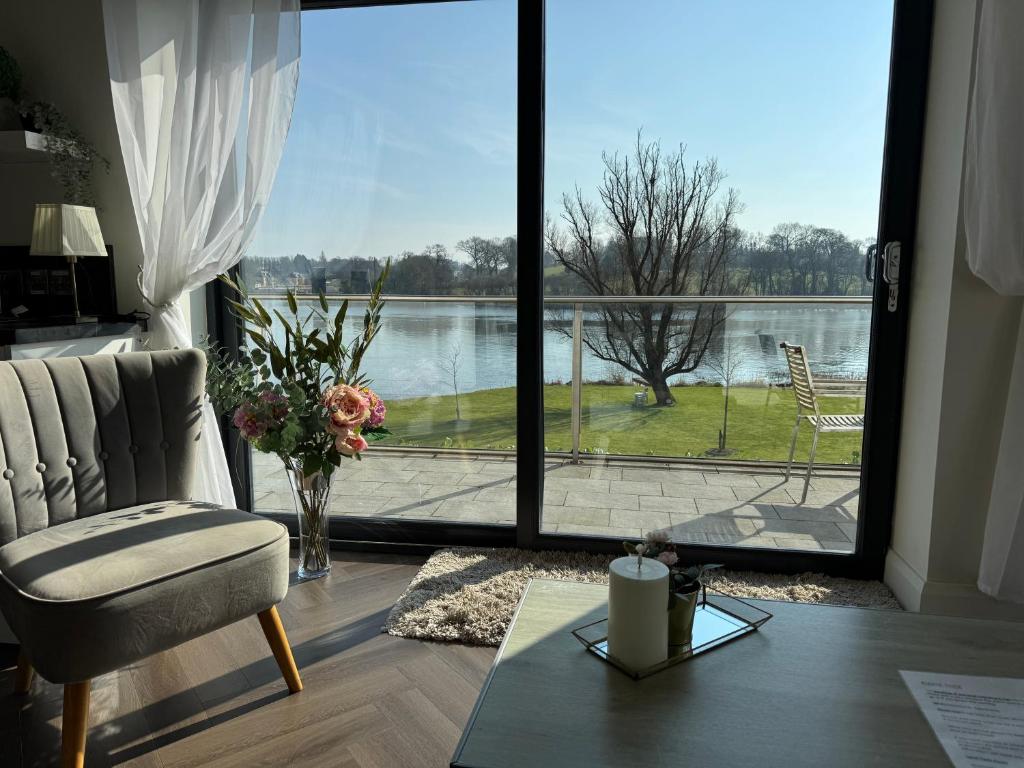 a living room with a view of a large window at Lakeside Apartment in Enniskillen