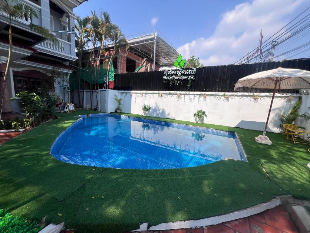 a swimming pool in the middle of a yard at Leaf Boutique SR in Siem Reap