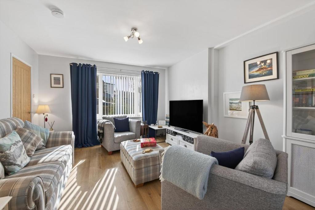 a living room with two couches and a tv at 2 Bed in Seahouses oc-86092 in North Sunderland