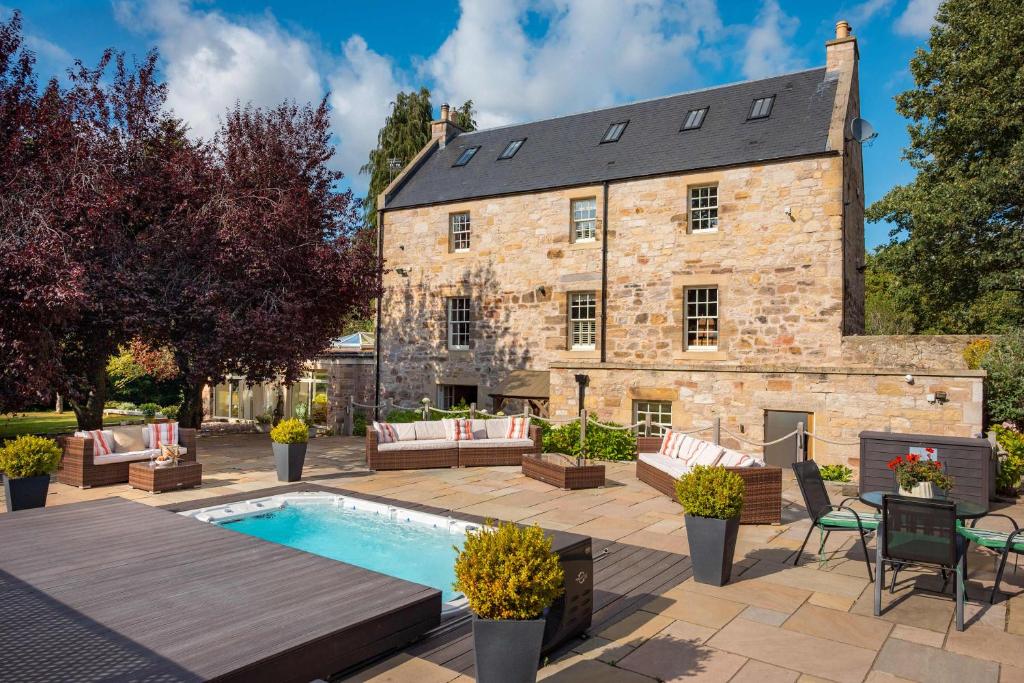 an estate with a swimming pool and a building at The Old Mill House Experience in Dalkeith