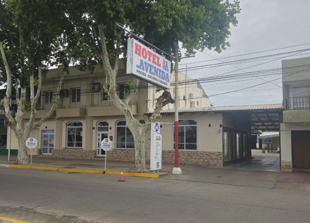 a sign for a store on the side of a street at Hotel Avenida in General Alvear