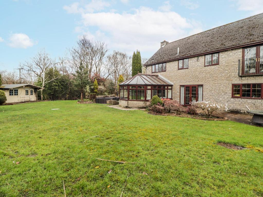 a large yard in front of a brick house at Willows Lodge at Carreg Llwyd in Cardiff