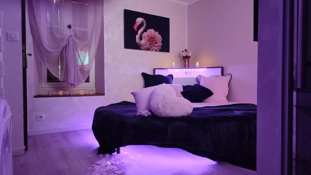 a purple bedroom with a bed with a stuffed animal on it at Suite hors du temps in Le Castellet