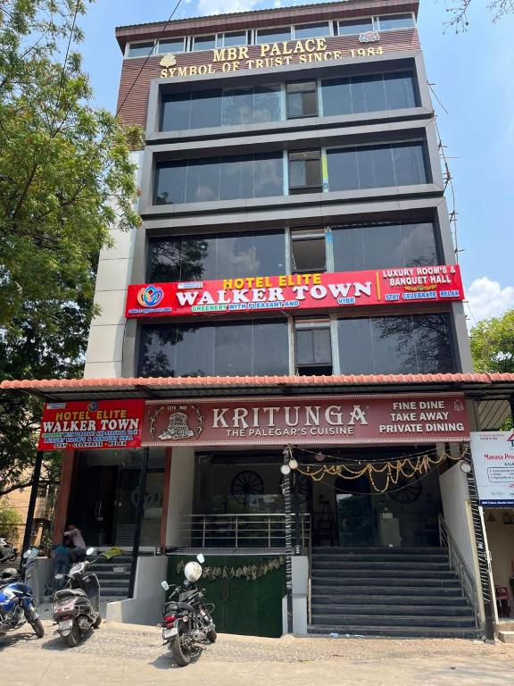a building with two motorcycles parked in front of it at Hotel Elite Walker Town in Hyderabad