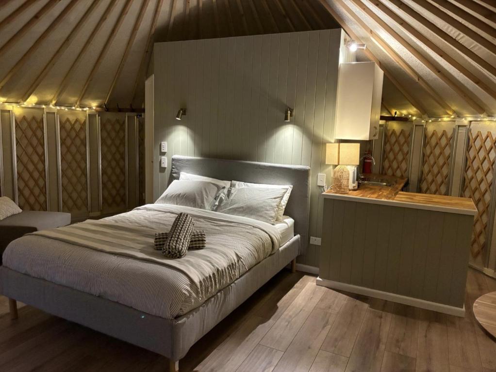 a bedroom with a large bed in a tent at Yurts at Yelverton in Yelverton