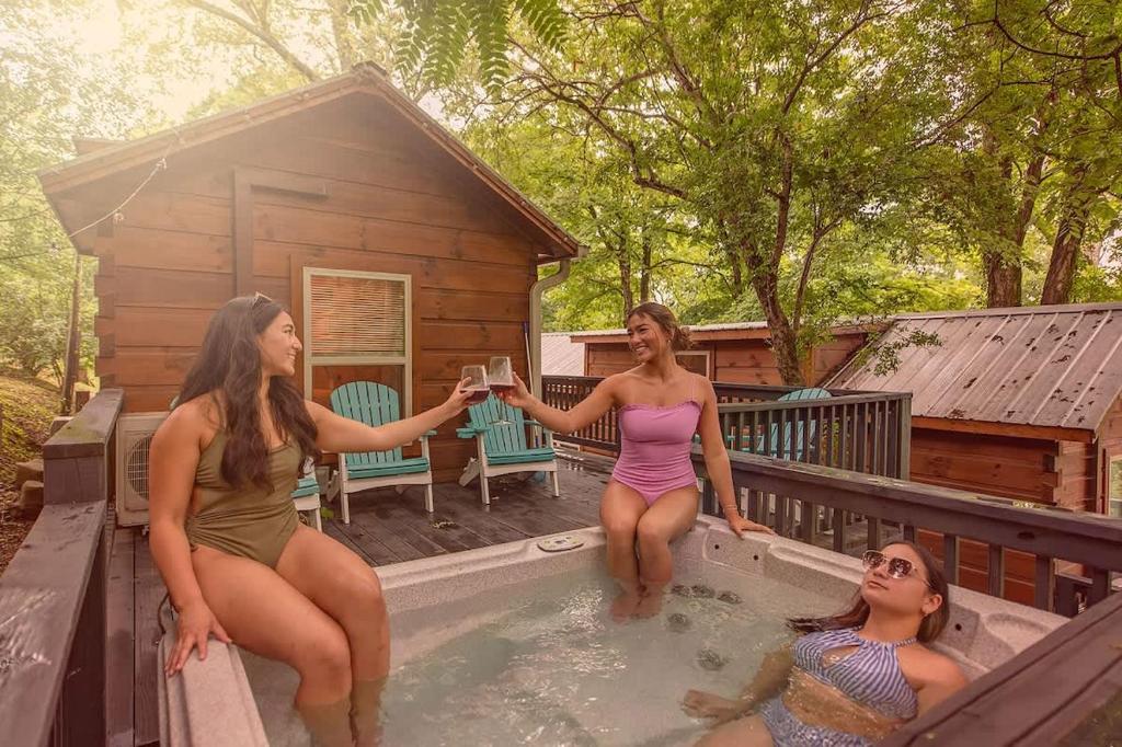 a group of women sitting in a swimming pool at Ani Cabin Tiny Home Bordered By National Forest in Chattanooga