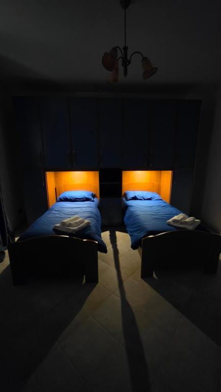 a bedroom with two beds in a dark room at La Francigena in Vetralla