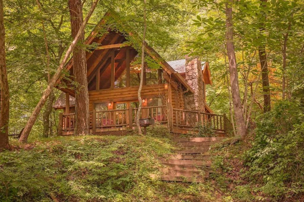 a log cabin in the woods with stairs in front at Ocoee Cabin Beautiful Cabin On The River's Edge in Ocoee