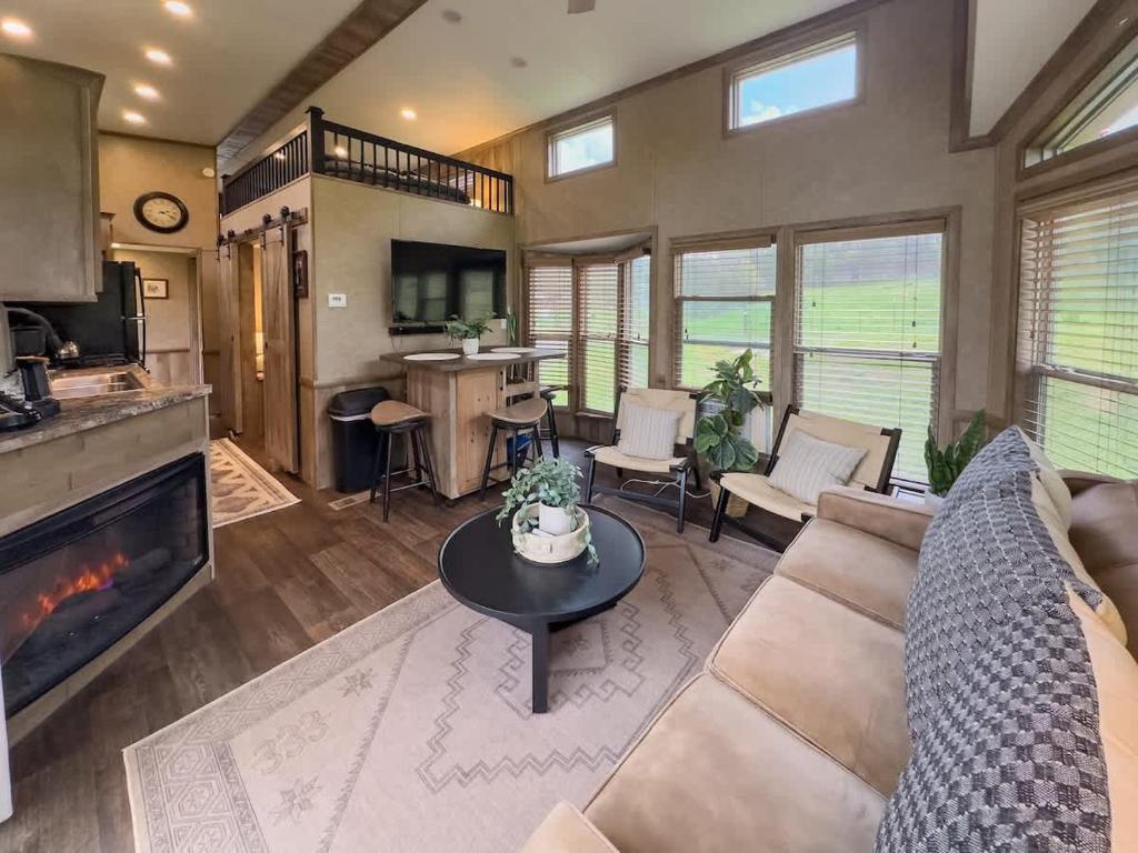 a living room with a couch and a fireplace at Quail Run Farm- Rustic Tiny Home 3 in Chattanooga
