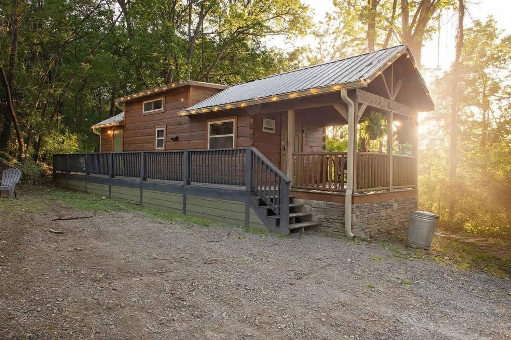 a log cabin with a porch and a deck at Thomas Cabin Forest Tiny Cabin With Hot Tub in Chattanooga