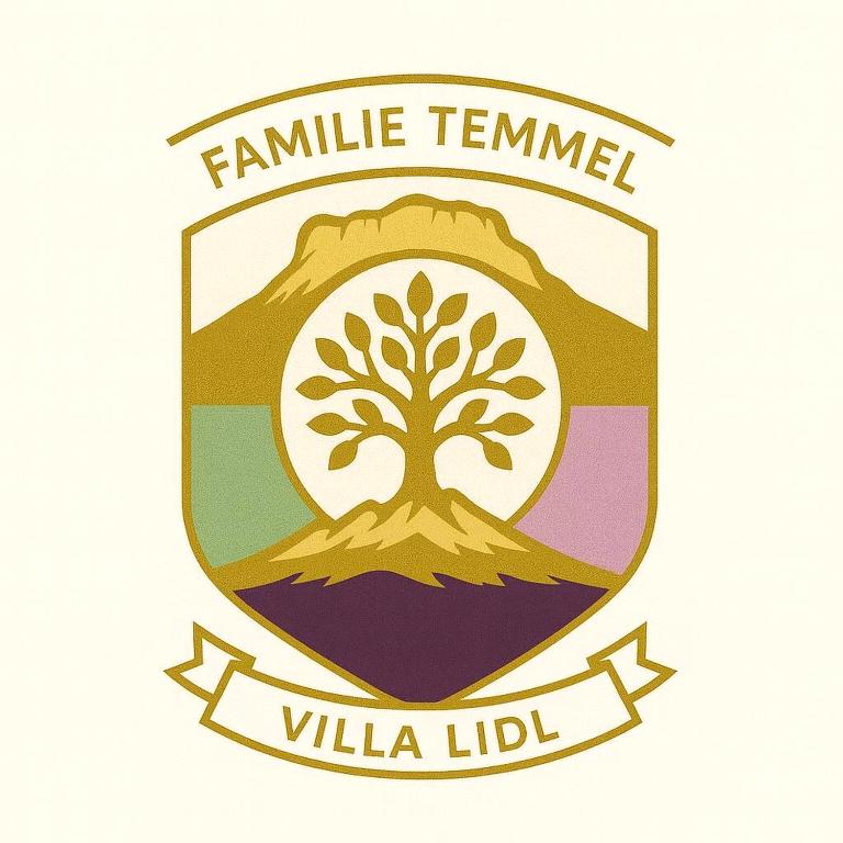 a tree in the center of a shield with the famille tamim villa at Villa Lidl Ferienwohnung in Altaussee