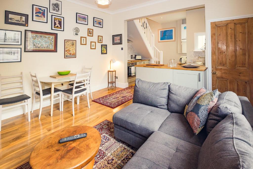 a living room with a couch and a table at Regency Square Town House in Brighton & Hove