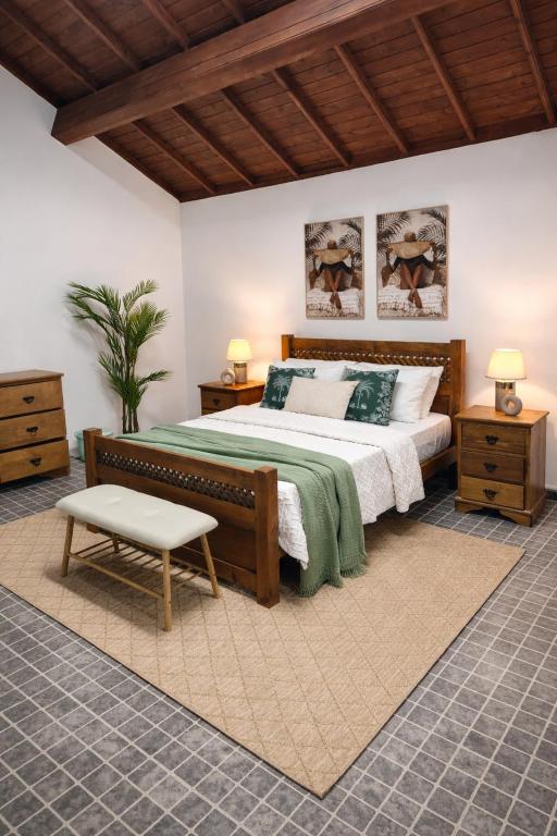 a bedroom with a large bed and two night stands at ViladaBaleiaBranca in Remédios
