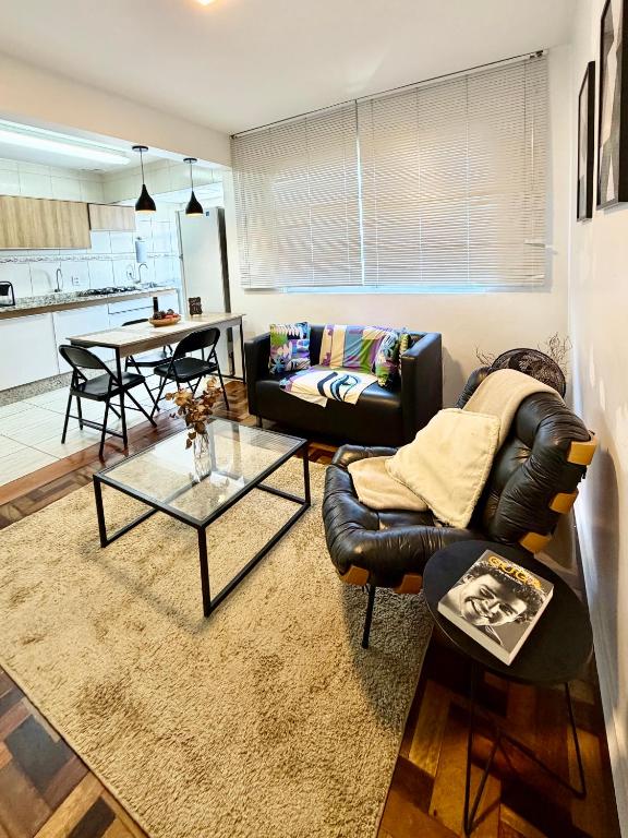 a living room with a couch and a table at Barriga Verde in Florianópolis