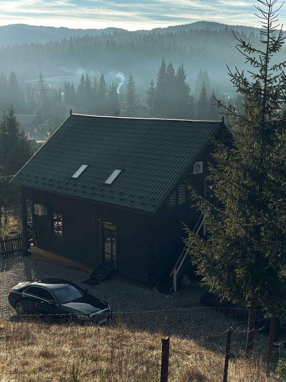 a house with a car parked in front of it at Вершина in Vorokhta