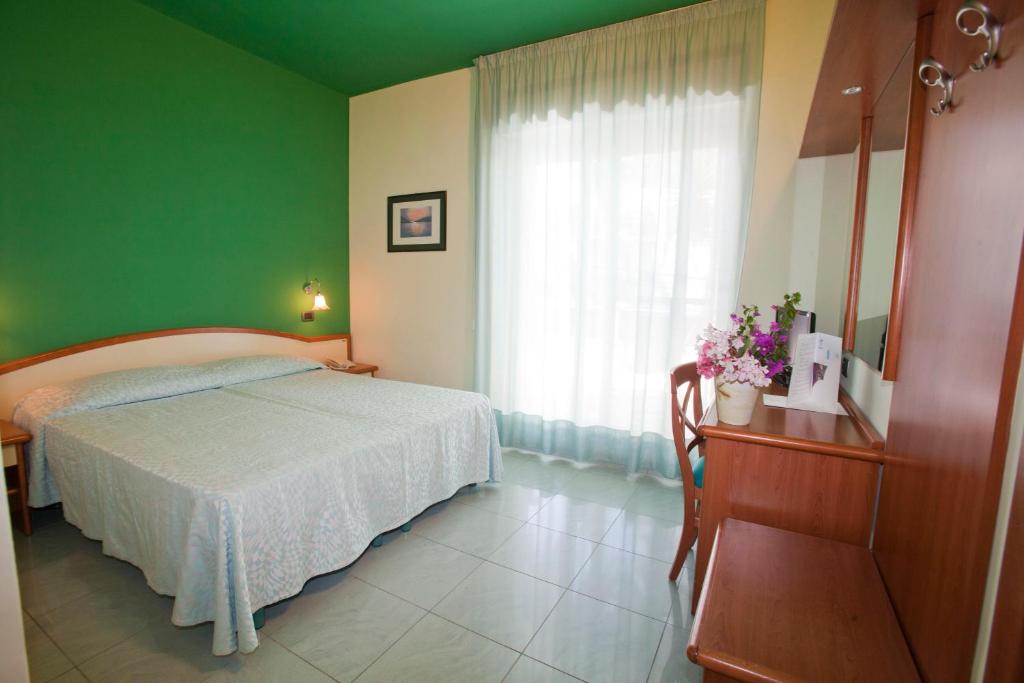 Postel nebo postele na pokoji v ubytování Hotel Gabbiano