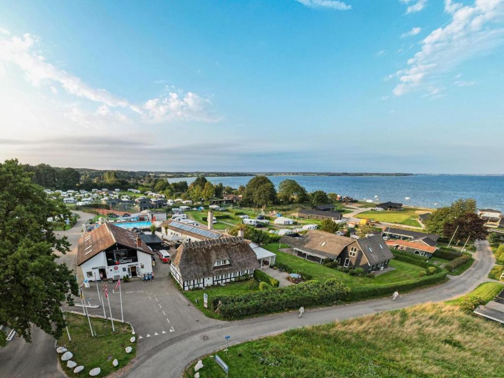 an aerial view of a small town with houses and the ocean at DCU-Camping Grønninghoved Strand in Sjølund
