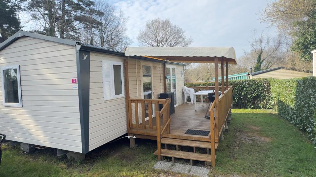 a tiny house with a porch and a gazebo at Lambé in Pont-Aven