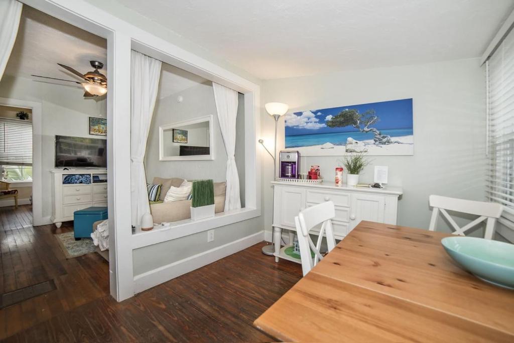 a dining room with a table and a room with a desk at Sunny PaG Island rental wbikes-just steps2beach in St. Pete Beach