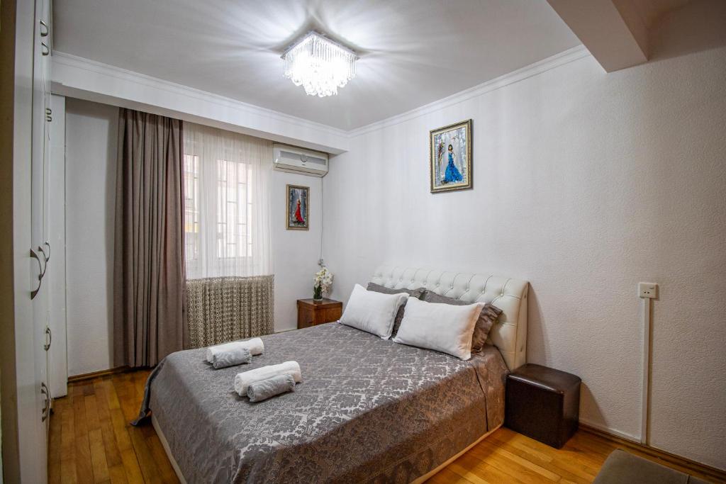 a bedroom with a bed with two towels on it at Cozy Apartment on Kostava in Tbilisi City