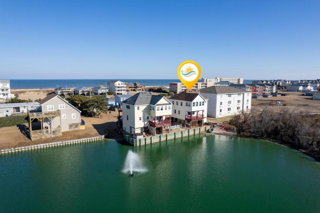 an aerial view of a large body of water with houses at 5066 - McBride's Shore Thing 2 in Kill Devil Hills