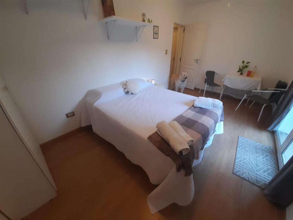 a bedroom with a large white bed in a room at Habitación en casa familiar "FILOMENA" in Puerto Madryn