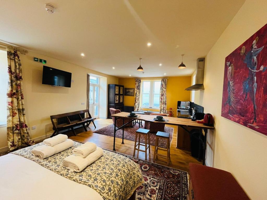 a room with a bed with two pillows on it at Black Isle Bar Apartment in Fort William