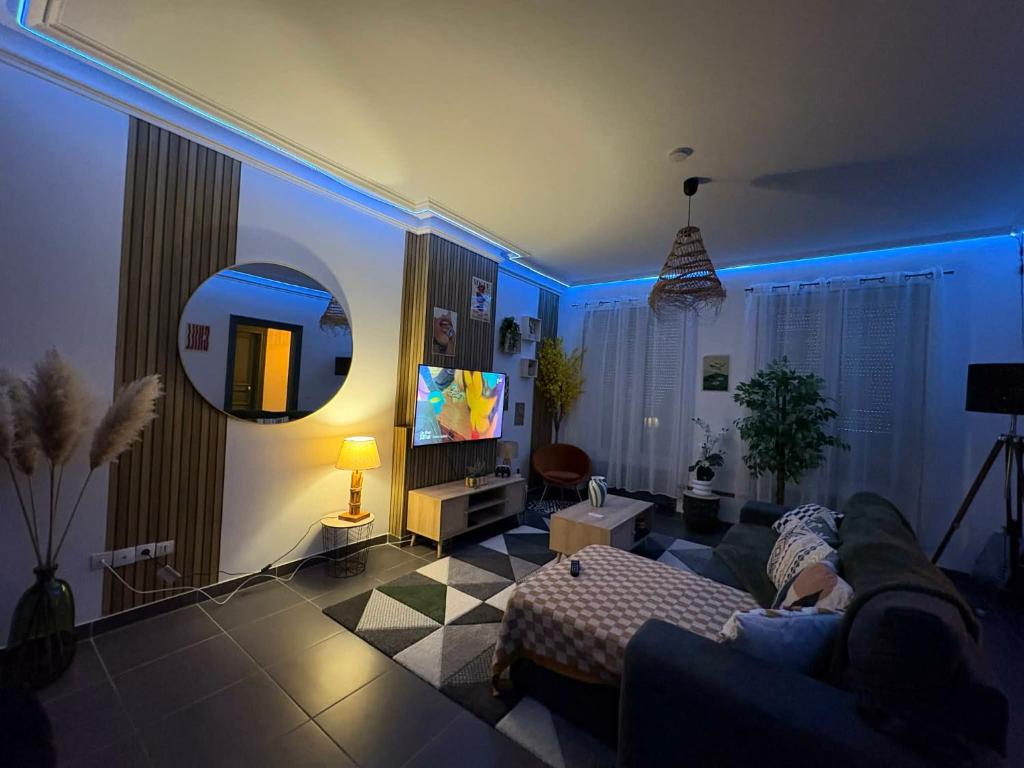 a living room with a couch and a tv at La Dryade in Braux