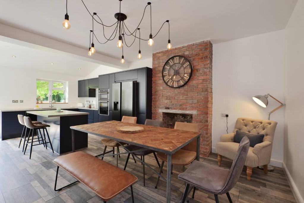 a kitchen and dining room with a table and a fireplace at Spacious Gate 3BR City 5mins Walk Pets Welcome in Hereford