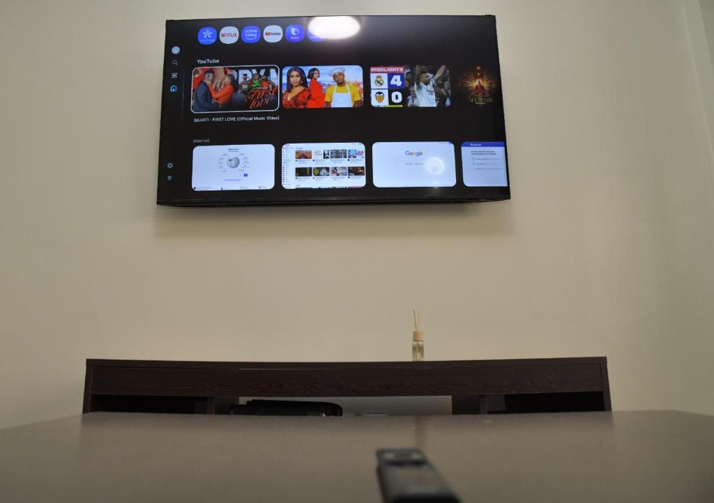 a flat screen tv hanging on a wall at Nivaro Homes in Nakuru