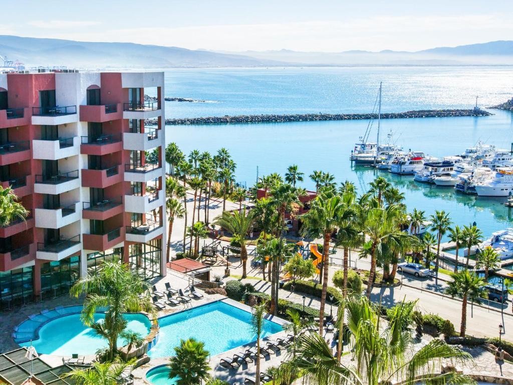 an aerial view of a resort with a pool and a marina at Hotel Coral & Marina in Ensenada