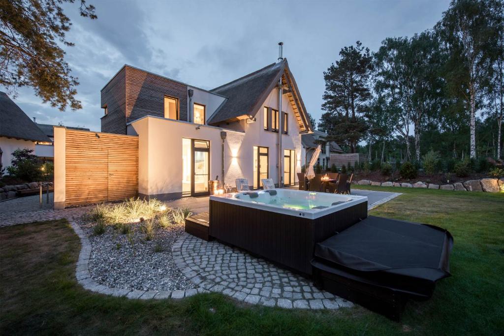 a house with a hot tub in the yard at Kapitänsweg 12 in Karlshagen