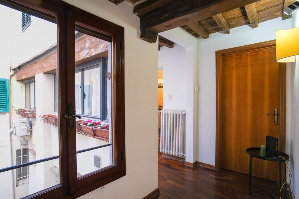 a room with a large window and a door at Drago D'oro Boutique Apartment in Florence