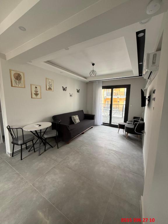 a living room with a couch and a table at Erdem Apart D4 in Dalaman