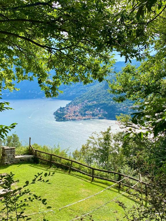 a view of a body of water with a fence at New IL RICCIO in Cernobbio
