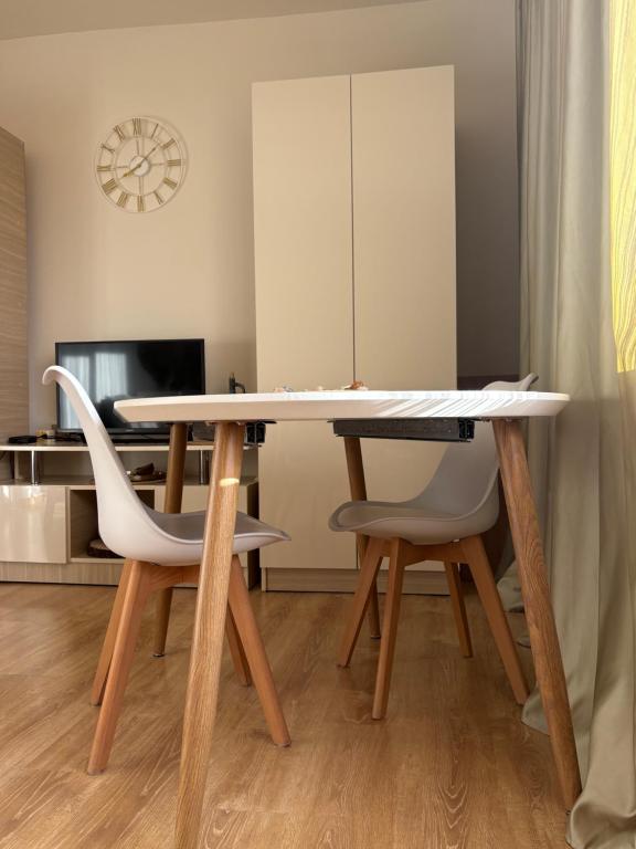 a dining room with a table and two chairs at TREFOIL in Lori Berd