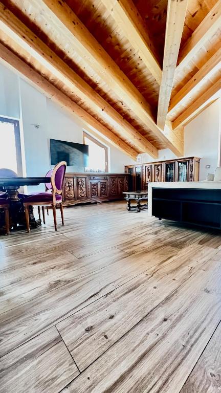 a large room with a table and a piano at Casa Stelvio in Turchi