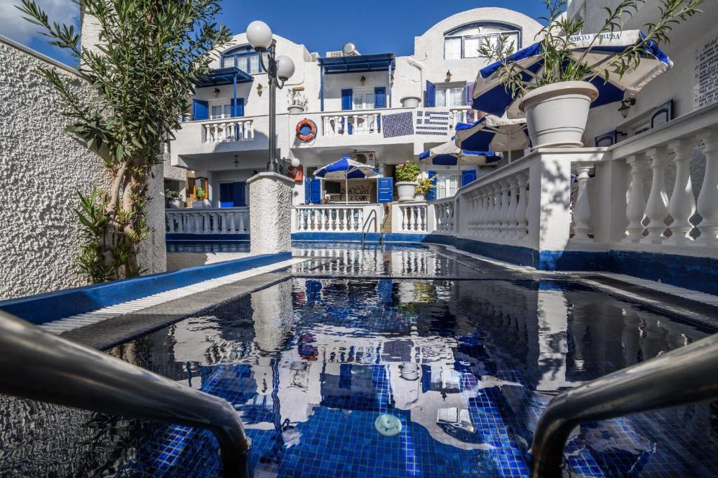 - une piscine dans la cour d'un bâtiment dans l'établissement Hotel Porto Perissa, à Perissa