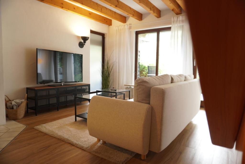 a living room with a couch and a television at Ferienwohnung EGS in Lahr