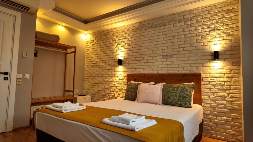 a bedroom with a large bed with towels on it at Hotel Zurich Oldtown in Antalya