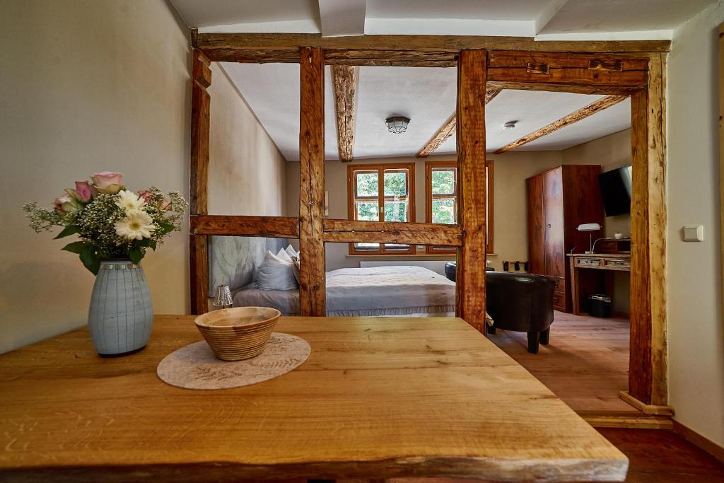 a dining room with a table and a bedroom at Schinkel Ferienunterkünfte Quedlinburg UNESCO Altstadt, Parkplatz inkl in Quedlinburg