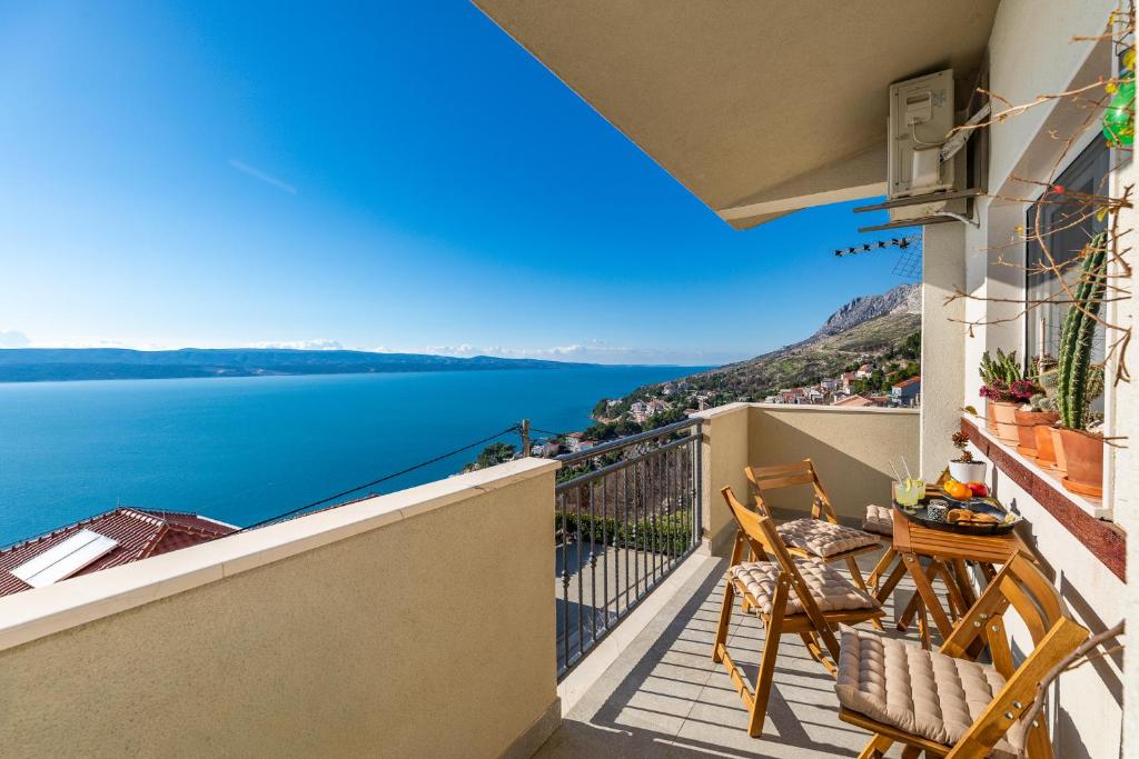 a balcony with chairs and a view of the water at Mimice Hills Luxury Penthouse 229 m2, Panoramic Wrap Terrace, Jacuzzi,BBQ in Mimice