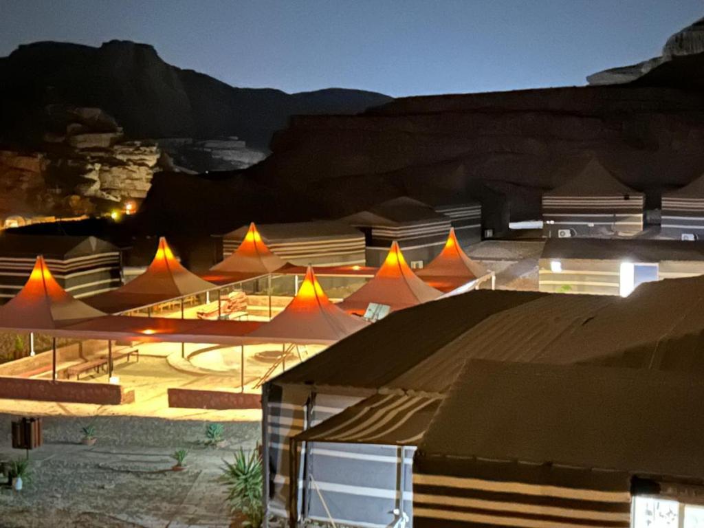 a group of tents with mountains in the background at Hillawi Private Desert Camp in Aqaba