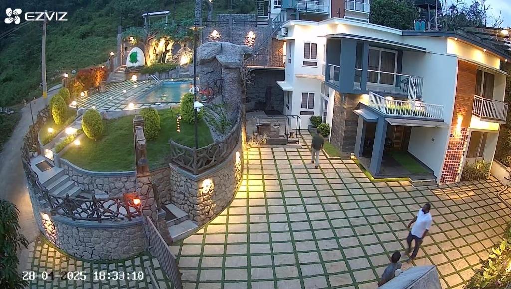 an aerial view of a house with a patio at Diga Vista Lake View 4BHK Swimming Pool Cottage Munnar in Munnar