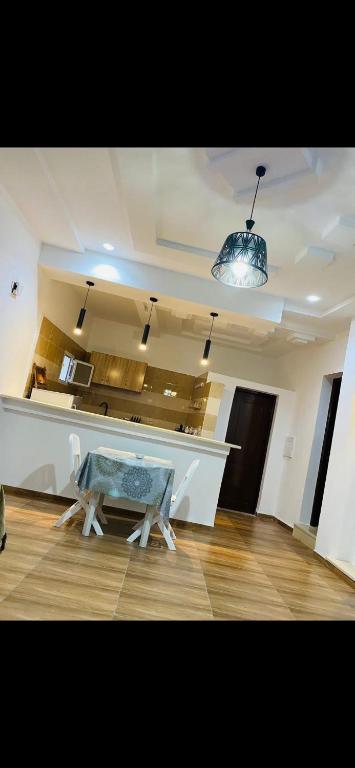 a living room with a counter and a table in it at Appartement 2 chambre in Gabès