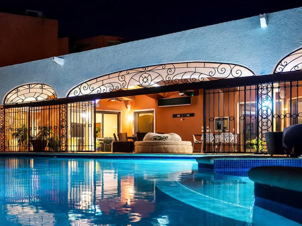 a swimming pool with a bed in a room at Solanza Hotel Hacienda in Cancún