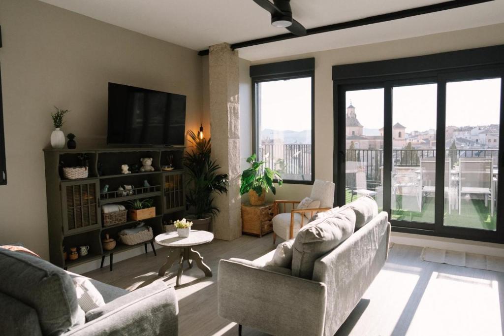 a living room with two couches and a tv at Casa Deitania I in Caravaca de la Cruz